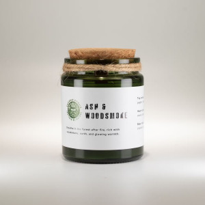 Vela de soja aroma madera y humo en frasco de vidrio verde con tapa de corcho.