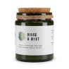 Vela de soja aroma musgo en frasco de vidrio verde con tapa de corcho natural.