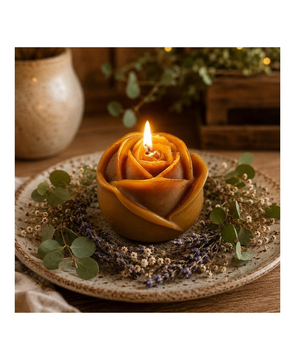 Vela  con forma de rosa de cera de abeja con mecha encendida.